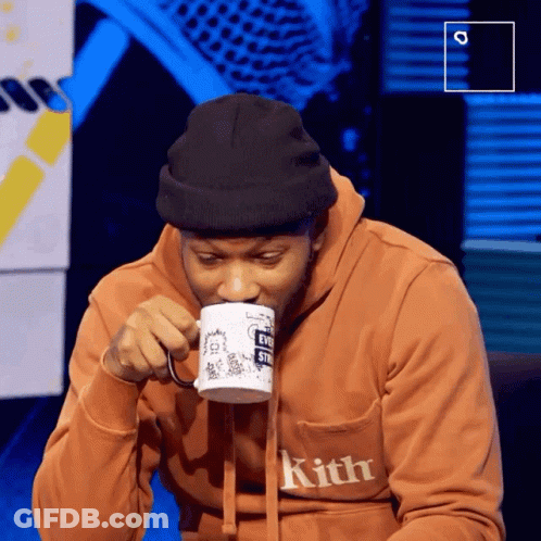 Man In Kith Sweatshirt Drinking From Cup GIF