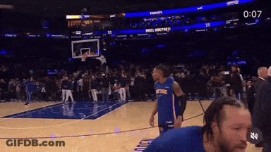 Man In Knicks Jersey On Basketball Court With Crowd GIF