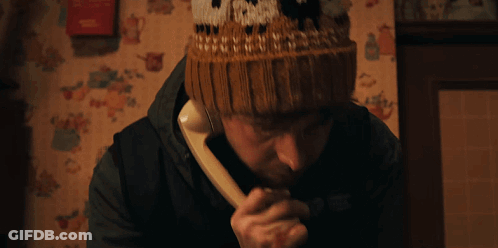 Man In Knitted Hat With North Talking On Phone GIF