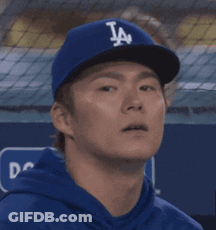 Man In LA Dodgers Hat Looks At Something GIF