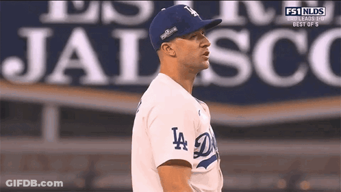 Man In LA Dodgers Jersey In Front Of Jalisco Sign GIF