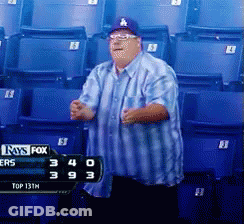 Man In LA Hat In Front Of Scoreboard GIF
