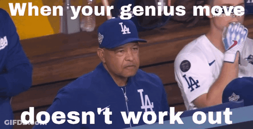Man In LA Hat Sitting In Dugout GIF