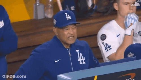 Man In LA Hat Sitting In Dugout GIF