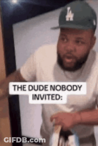 Man In LA Hat Standing In Doorway With Sign The Dude Nobody Invited GIF