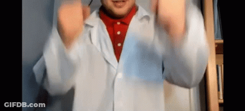 Man In Lab Coat And Red Shirt Making Funny Face GIF