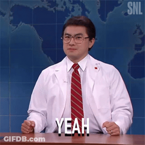 Man In Lab Coat And Tie Sitting At Desk Saying Yeah GIF