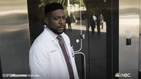 Man In Lab Coat And Tie With NBC Logo GIF