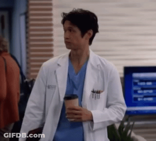 Man In Lab Coat Holding Coffee Cup GIF