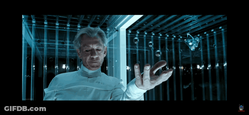 Man In Lab Coat Holding Something In Dark Room GIF