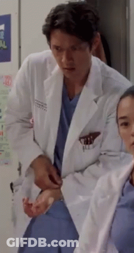 Man In Lab Coat Next To Woman In Scrubs GIF
