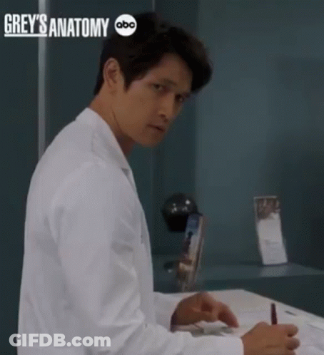 Man In Lab Coat Sitting At Desk With Grey's Anatomy ABC GIF