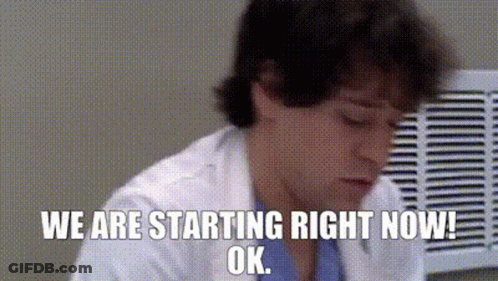 Man In Lab Coat Sitting In Front Of Fan GIF