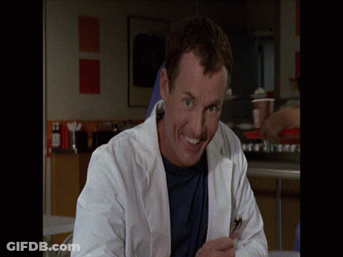 Man In Lab Coat Smiling With Cell Phone GIF