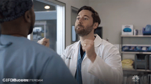 Man In Lab Coat Talking To Man In Scrubs #NewAmsterdam GIF