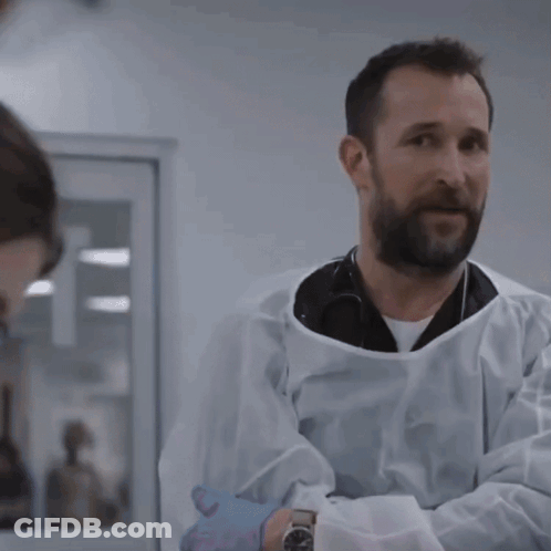 Man In Lab Coat Talking To Man With Watch GIF