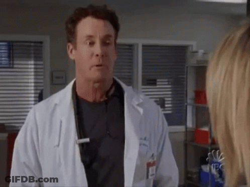 Man In Lab Coat Talking To Woman GIF