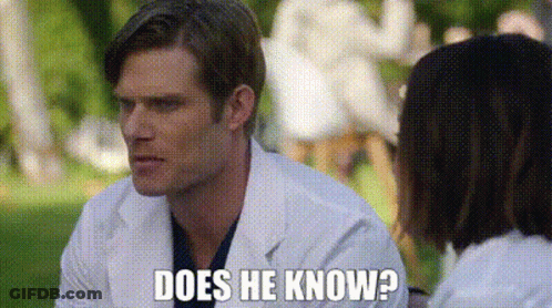 Man In Lab Coat Talking To Woman In Park GIF