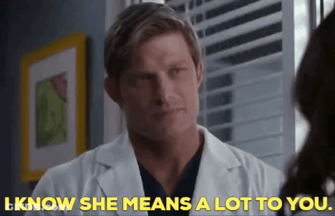 Man In Lab Coat Talking To Woman GIF