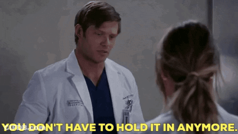 Man In Lab Coat Telling Woman You Don't Have To Hold It In Anymore GIF