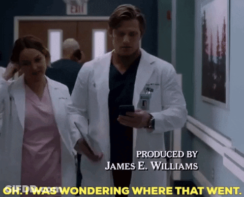 Man In Lab Coat Walking With Nurse In Hospital Hallway GIF
