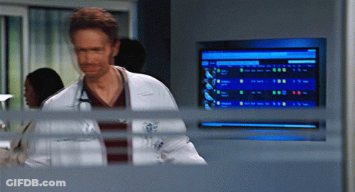 Man In Lab Coat With Stethoscope Standing In Front Of Monitor GIF