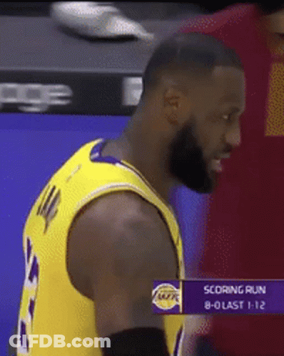 Man In Lakers Jersey Standing In Front Of Scoring Run Screen GIF