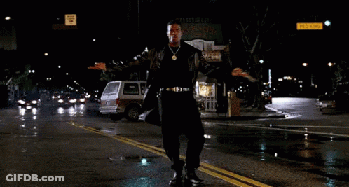 Man In Leather Coat Dancing On Wet Street GIF