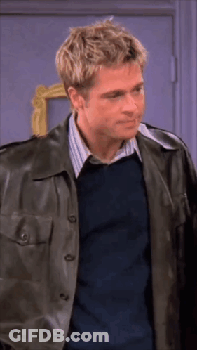 Man In Leather Jacket And Blue Shirt Standing Before Door GIF