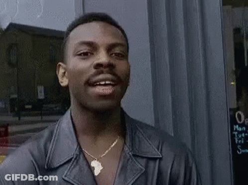 Man In Leather Jacket And Necklace Smiling GIF