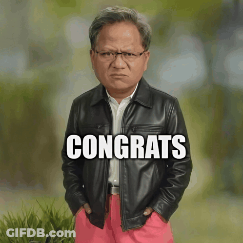 Man In Leather Jacket And Pink Pants In Front Of Congrats Sign GIF