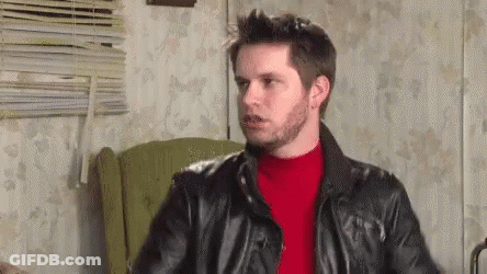 Man In Leather Jacket And Red Sweater Sitting In Chair GIF