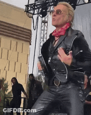 Man In Leather Jacket And Sunglasses Dancing On Stage GIF
