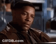 Man In Leather Jacket And Tie Sitting In Chair GIF