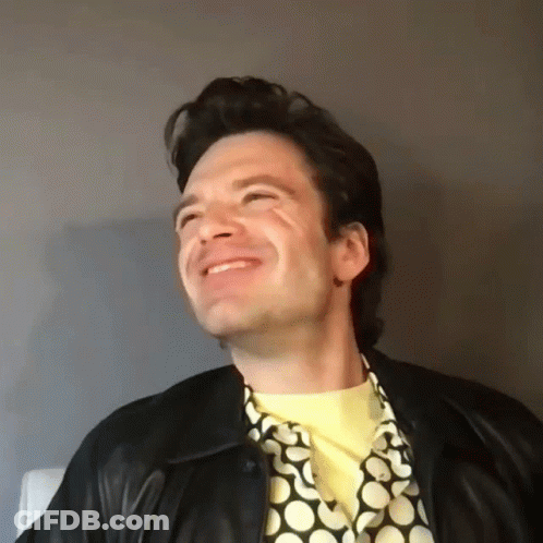 Man In Leather Jacket And Yellow Shirt Smiling GIF