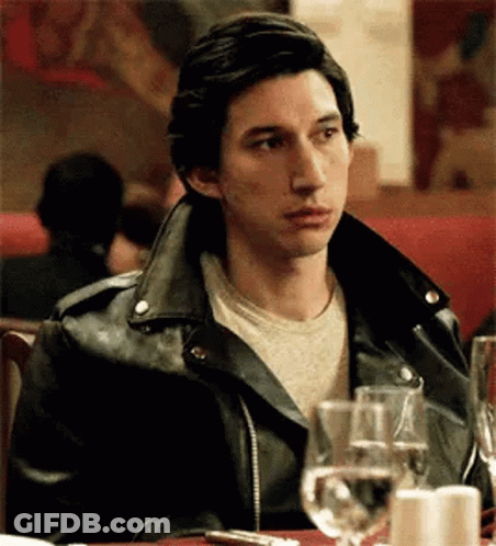 Man In Leather Jacket At Table With Wine Glasses GIF