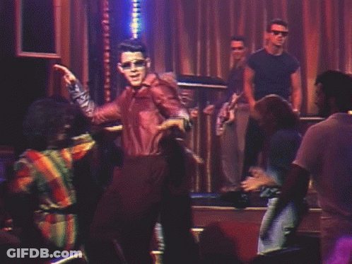 Man In Leather Jacket Dancing In Dark Room GIF