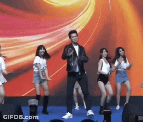 Man In Leather Jacket Dancing With Group Of Girls GIF