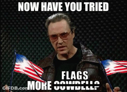 Man In Leather Jacket Holding American Flags Now Have You Tried Flags More Cowbell GIF