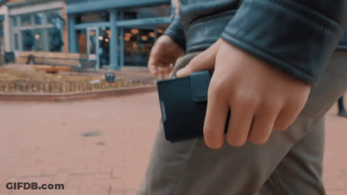 Man In Leather Jacket Holding Black Wallet GIF