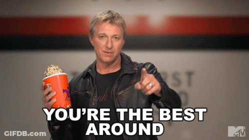 Man In Leather Jacket Holding Popcorn And Pointing GIF