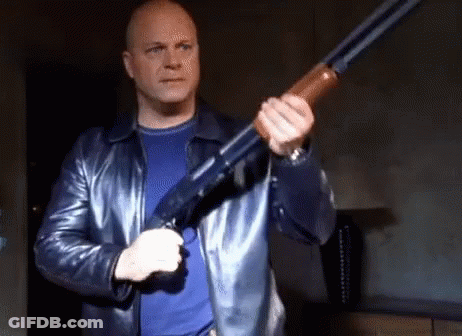 Man In Leather Jacket Holding Shotgun GIF