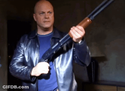 Man In Leather Jacket Holding Shotgun GIF