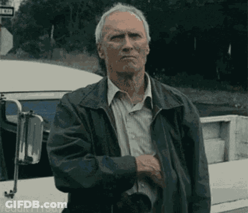 Man In Leather Jacket In Front Of Bus GIF