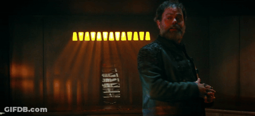 Man In Leather Jacket In Front Of True Captain Sign GIF