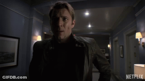 Man In Leather Jacket In Hallway With Netflix GIF