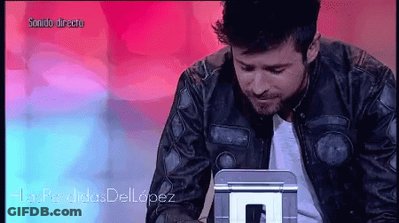 Man In Leather Jacket Looking At Sonido Directo Screen GIF