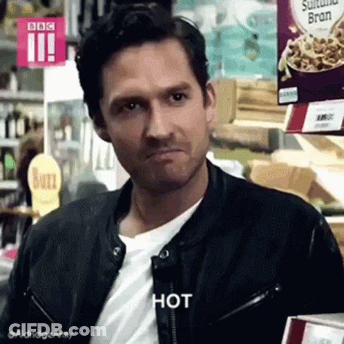 Man In Leather Jacket Making Face In Grocery Store GIF