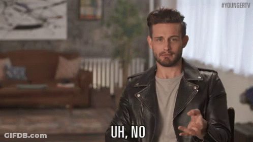 Man In Leather Jacket Making Funny Face In Chair GIF