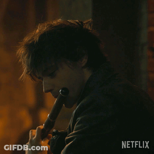 Man In Leather Jacket Playing Flute With Netflix Logo GIF